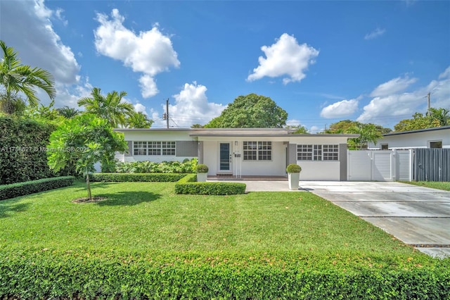 single story home featuring fence, concrete driveway, a gate, stucco siding, and a front yard