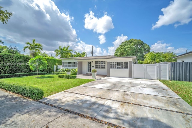 single story home with stucco siding, concrete driveway, a front yard, a gate, and fence