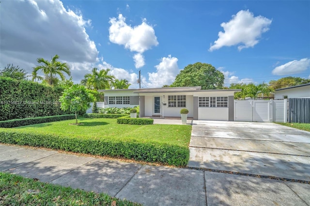 ranch-style house with stucco siding, a front lawn, a gate, fence, and concrete driveway