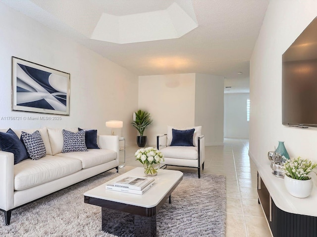 living room featuring light tile patterned flooring and a textured ceiling