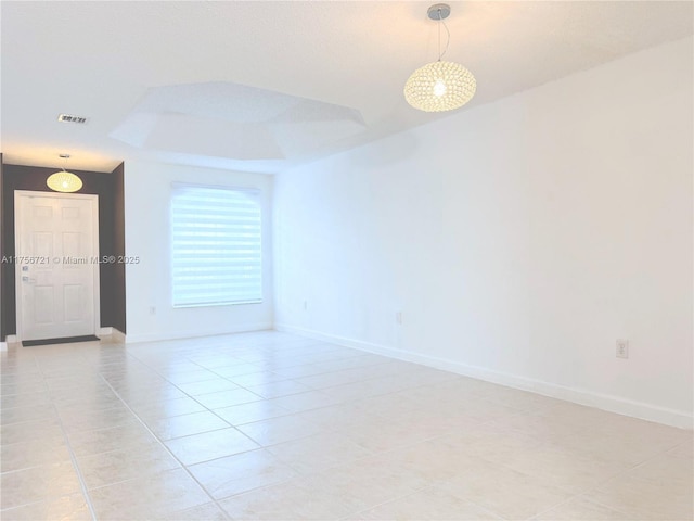 unfurnished room with light tile patterned floors, visible vents, and baseboards