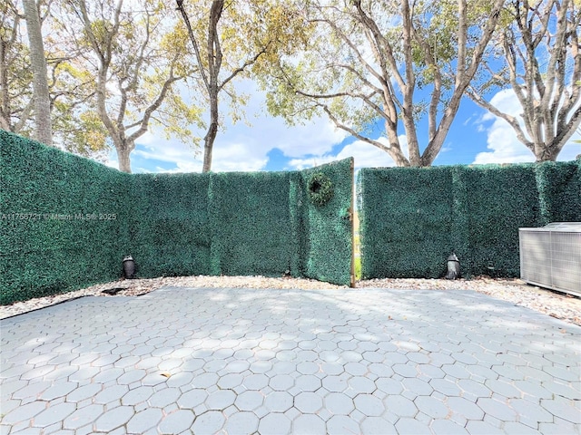 view of yard featuring central AC unit and fence