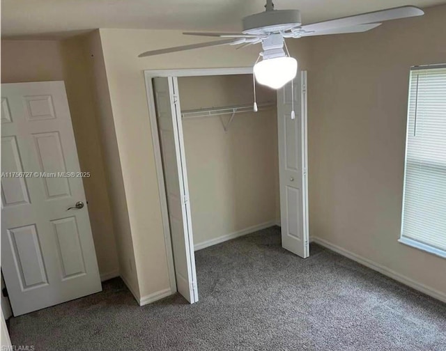 unfurnished bedroom with a closet, carpet flooring, a ceiling fan, and baseboards