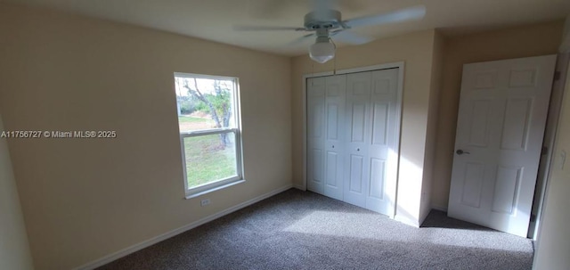 unfurnished bedroom featuring a closet, multiple windows, carpet flooring, and baseboards