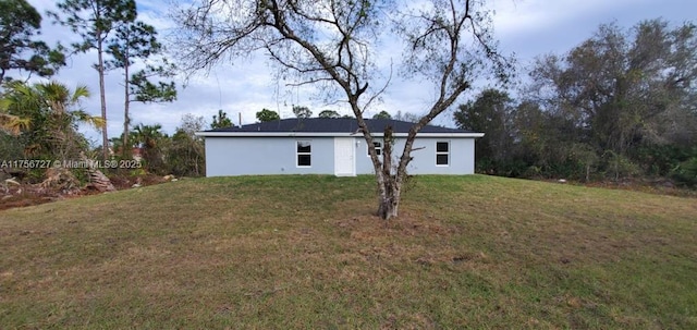 exterior space featuring a front lawn and stucco siding