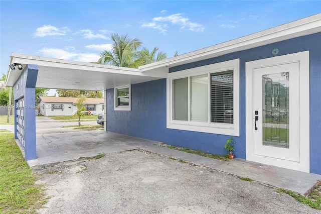 exterior space with driveway and an attached carport