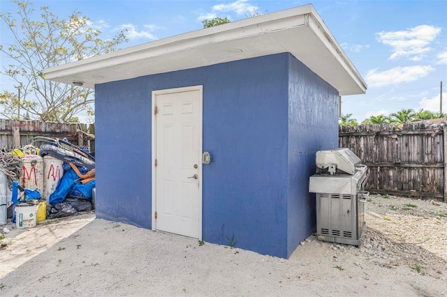 view of shed featuring fence