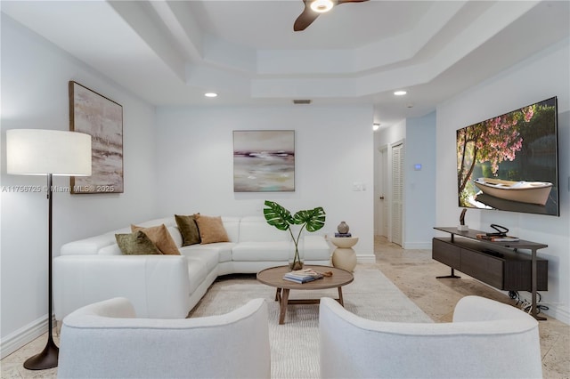 living area featuring visible vents, baseboards, a raised ceiling, and recessed lighting