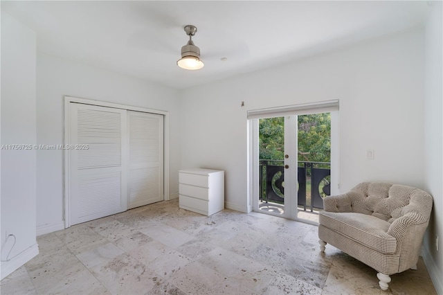 sitting room with baseboards and french doors