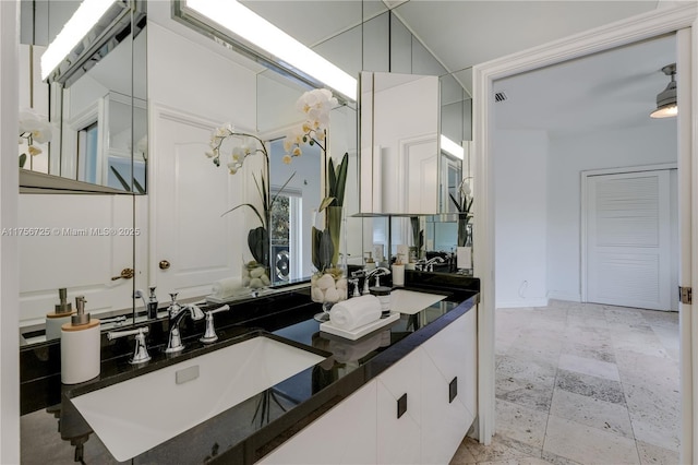 bathroom featuring a sink and double vanity