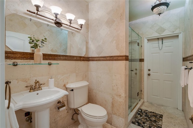 bathroom featuring toilet, a stall shower, a chandelier, and tile walls