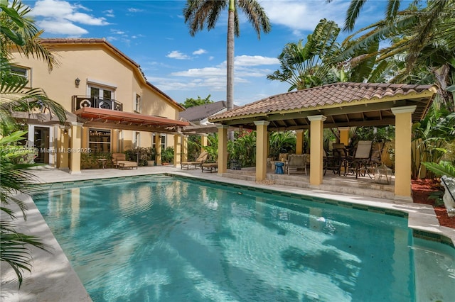 pool featuring a patio area, fence, and a gazebo