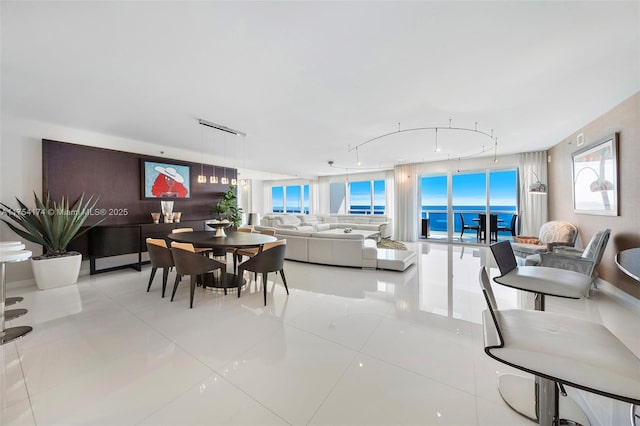 dining area with tile patterned floors and a water view