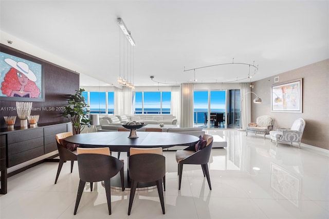 dining space featuring light tile patterned flooring and visible vents