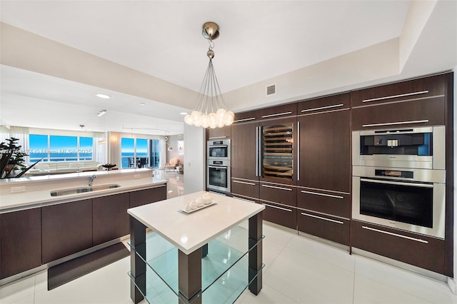 kitchen with visible vents, modern cabinets, light countertops, and a sink