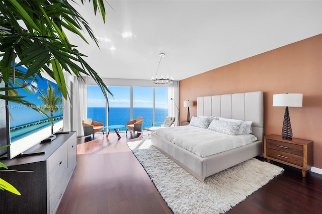 bedroom featuring dark wood-style flooring and a chandelier