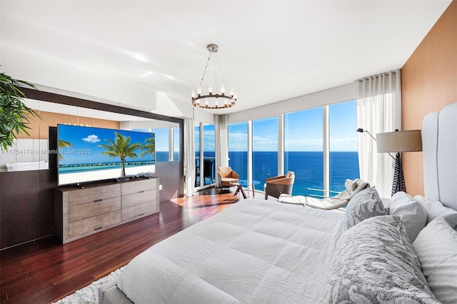 bedroom with a notable chandelier and wood finished floors