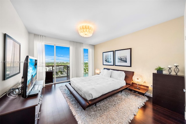 bedroom featuring dark wood-style floors and access to outside