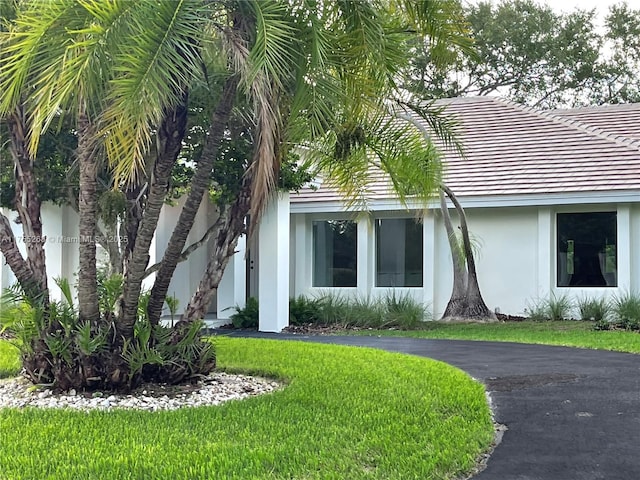 8513 SW 169th Ter, Palmetto Bay, FL 33157 - view of side of property with a tiled roof, a yard, and stucco siding