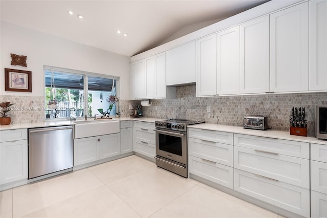 kitchen featuring light tile patterned floors, appliances with stainless steel finishes, light countertops, and a sink