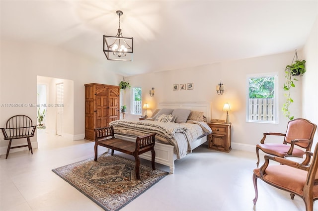 bedroom with baseboards, vaulted ceiling, and a notable chandelier