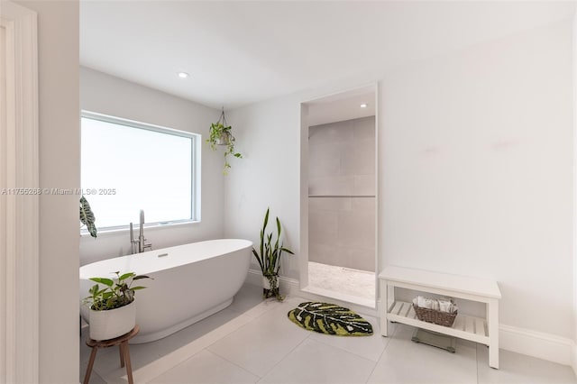 full bath with tile patterned flooring, a freestanding tub, recessed lighting, baseboards, and walk in shower