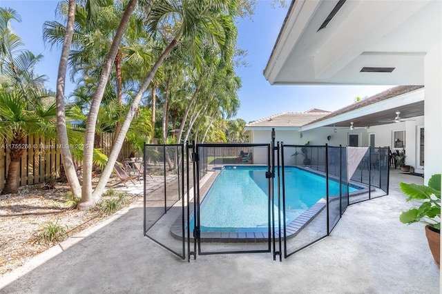 view of swimming pool featuring fence, a fenced in pool, and a patio