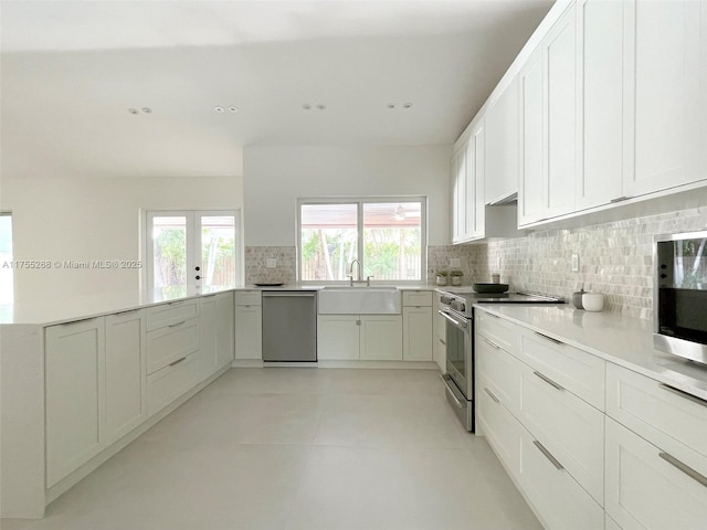 8513 SW 169th Ter, Palmetto Bay, FL 33157 - kitchen featuring a sink, decorative backsplash, appliances with stainless steel finishes, and a healthy amount of sunlight
