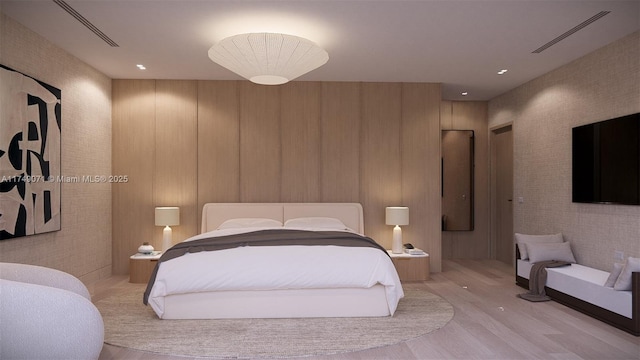 bedroom with visible vents and wood finished floors