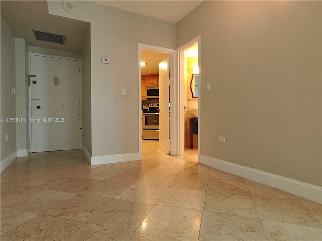 spare room featuring marble finish floor, visible vents, and baseboards