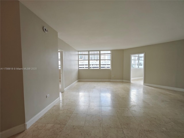 spare room featuring baseboards