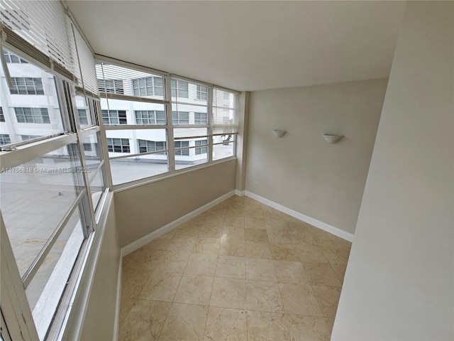 empty room featuring baseboards