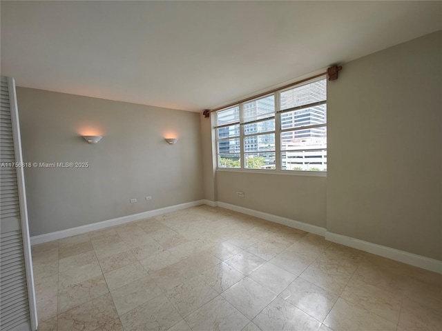 empty room featuring baseboards