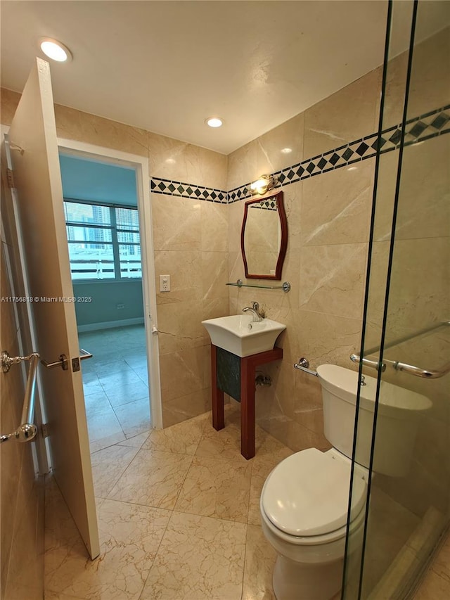 bathroom with recessed lighting, tile walls, toilet, and an enclosed shower