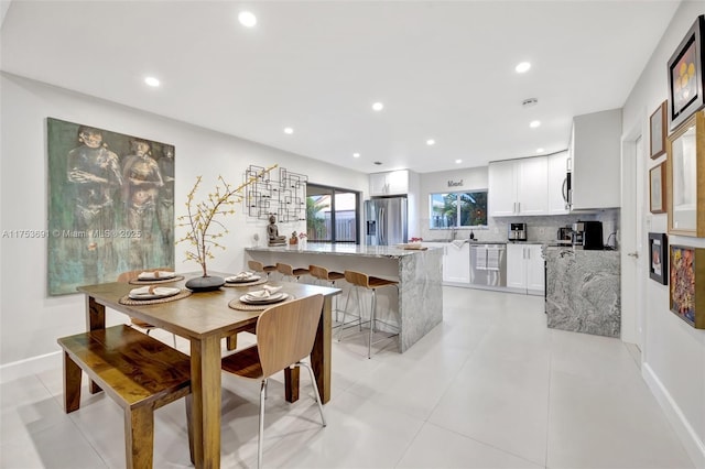 dining room with recessed lighting, baseboards, and light tile patterned floors