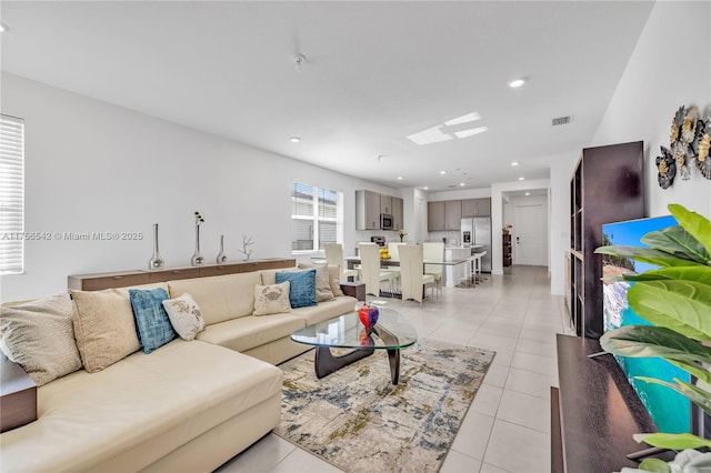 living room with recessed lighting, visible vents, and light tile patterned floors