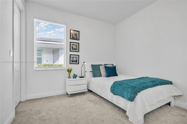 carpeted bedroom with baseboards