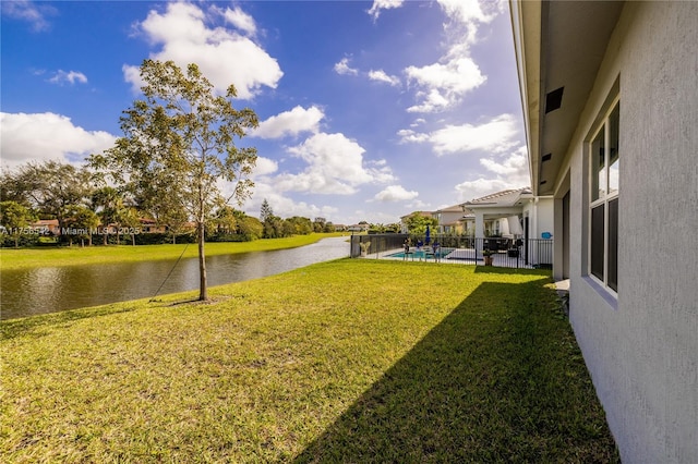 view of yard featuring a water view and a fenced in pool