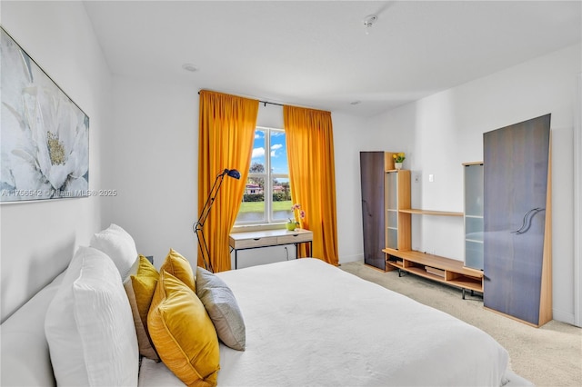 bedroom with carpet flooring and baseboards