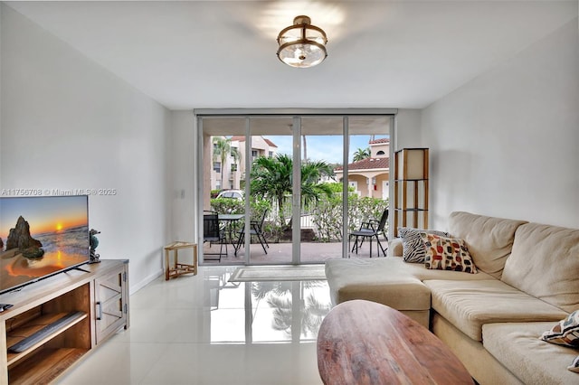 living room featuring light tile patterned floors, baseboards, and floor to ceiling windows