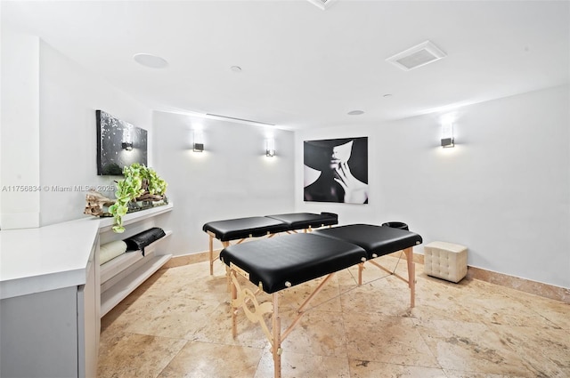 game room with stone finish floor and visible vents