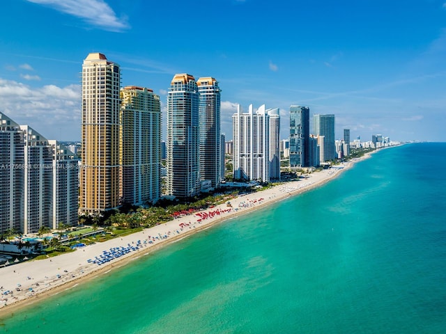 aerial view featuring a water view, a view of the beach, and a city view