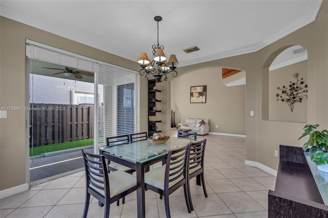 dining space featuring baseboards, visible vents, light tile patterned flooring, ornamental molding, and ceiling fan with notable chandelier