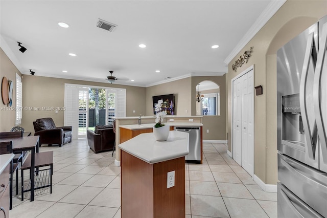 15509 SW 139th Ct, Miami, FL 33177 - kitchen with appliances with stainless steel finishes, an island with sink, arched walkways, open floor plan, and ornamental molding