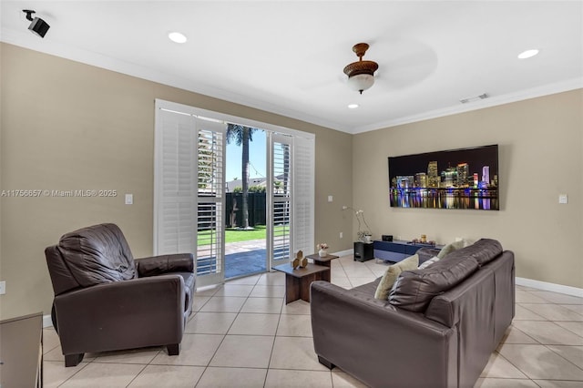 living room with crown molding, light tile patterned flooring, and visible vents