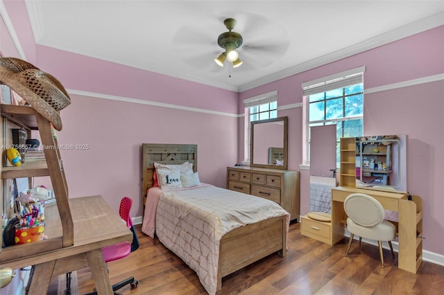 bedroom with ceiling fan, baseboards, wood finished floors, and crown molding