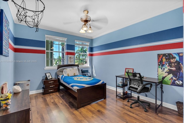 bedroom with baseboards, a ceiling fan, wood finished floors, and crown molding