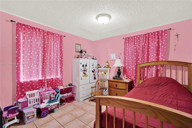 tiled bedroom with a textured ceiling