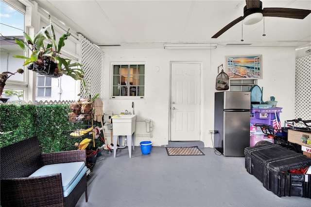 exterior space featuring freestanding refrigerator and a ceiling fan