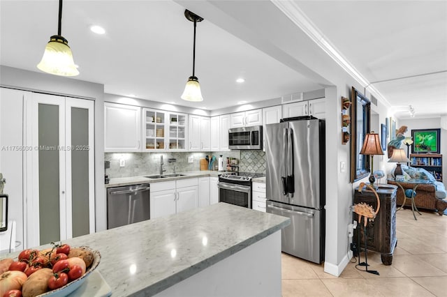 kitchen with light tile patterned floors, visible vents, appliances with stainless steel finishes, ornamental molding, and a sink